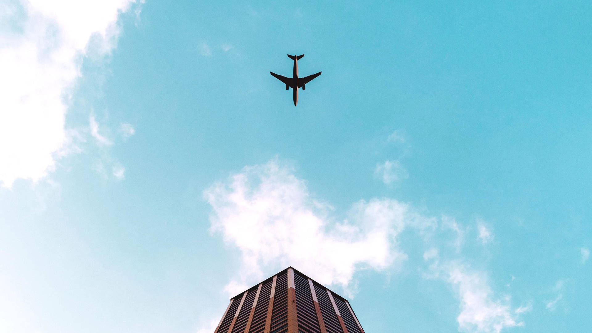 Hd Plane Flying Over Building Background