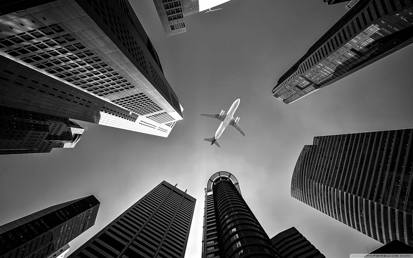 Hd Plane Flying Over Skyscrapers Background