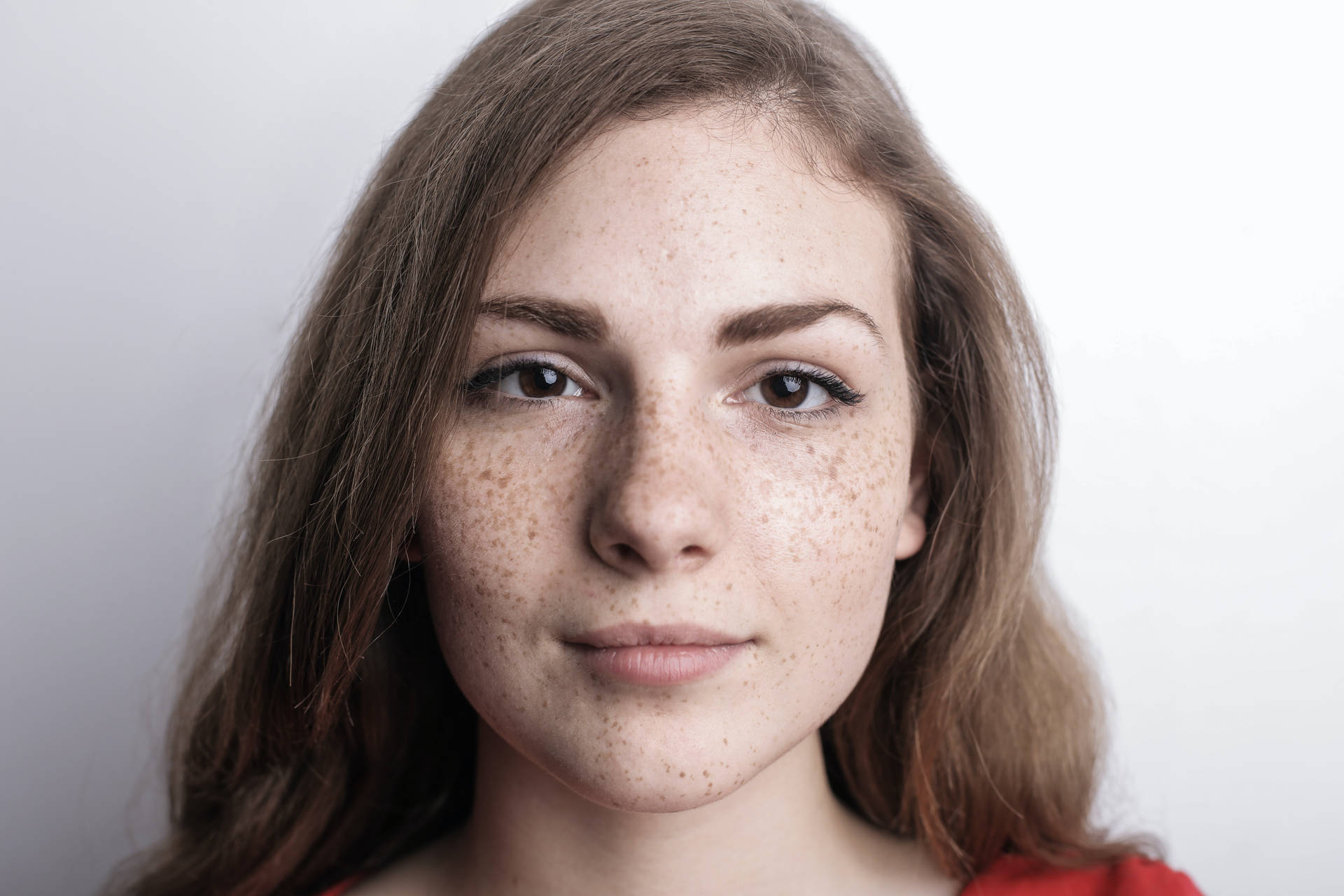 Headshot Of A Girl With Freckles On Face