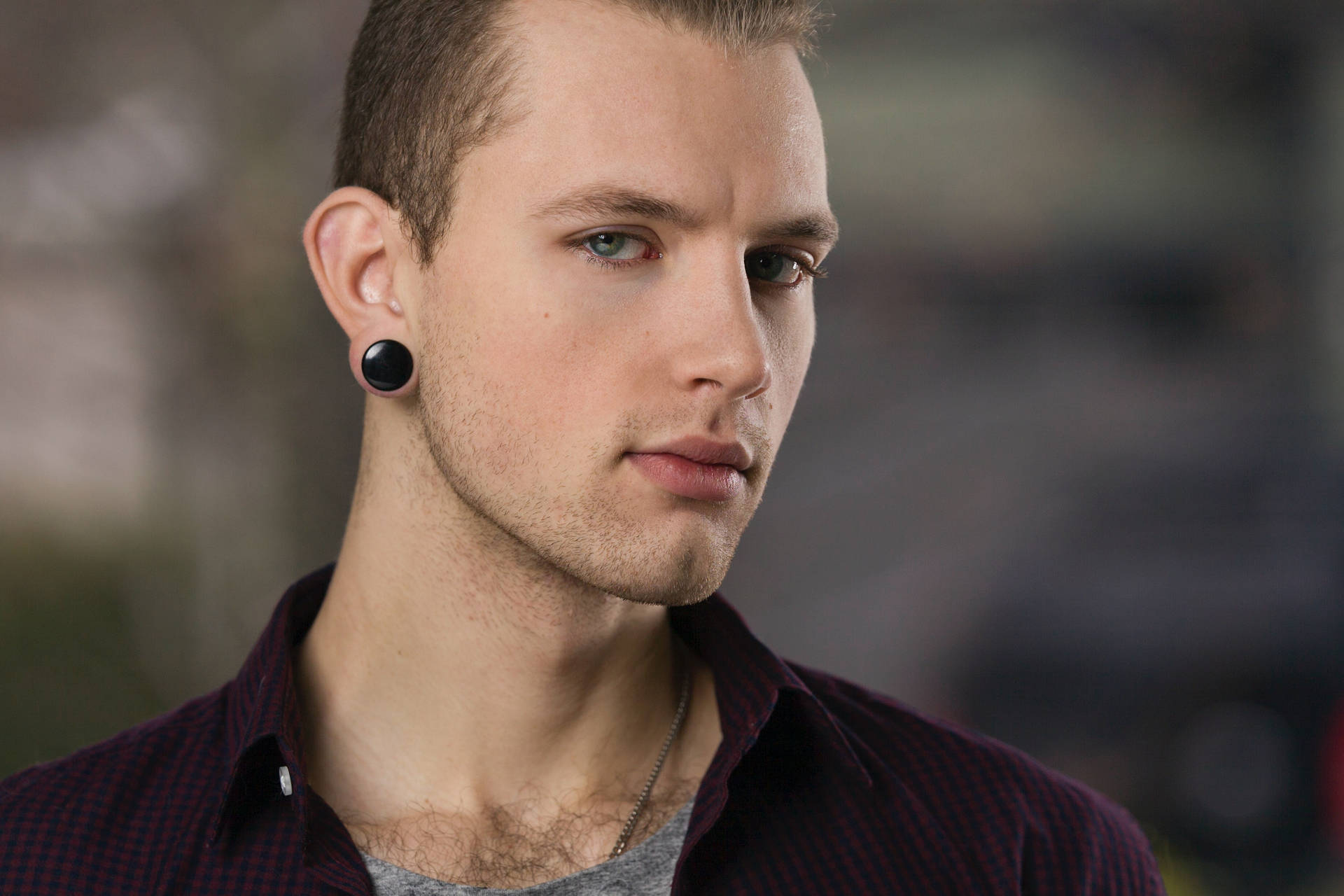 Headshot Of A Man With An Earring Background