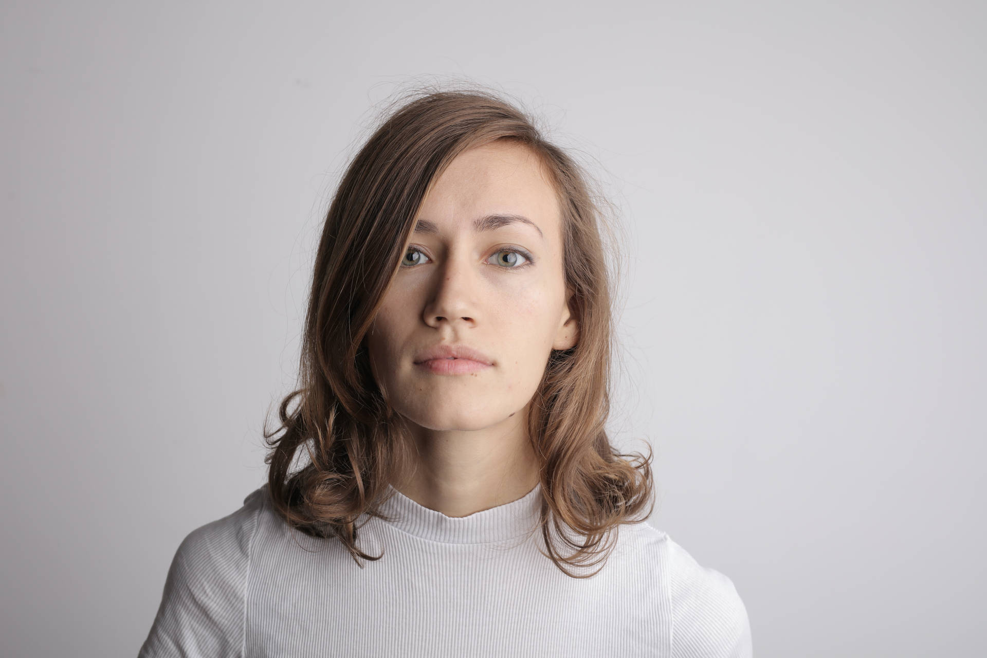 Headshot Of A Woman In Plain Background