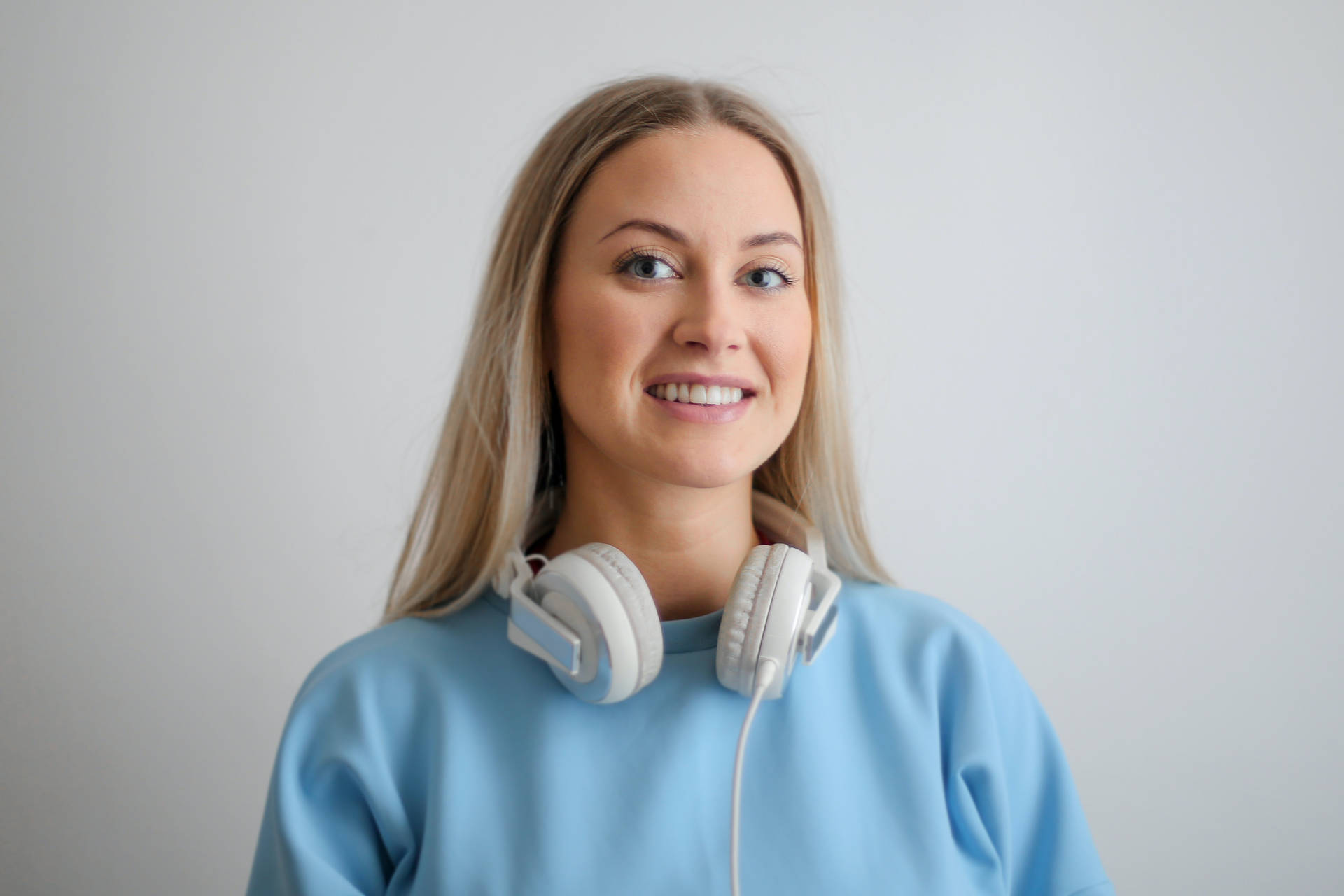 Headshot Of Girl Wearing Headphones And Blue Top