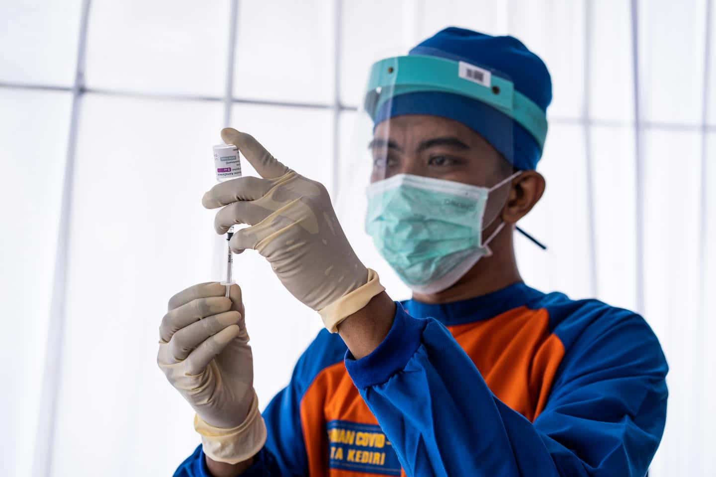 Health Worker Administering Astrazeneca's Covax Vaccine In East Java. Background