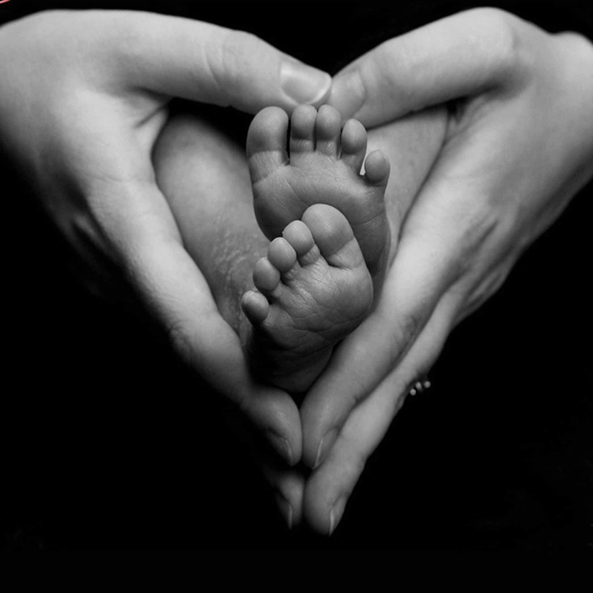 Heart Shaped Hands Cradling Baby Feet Background