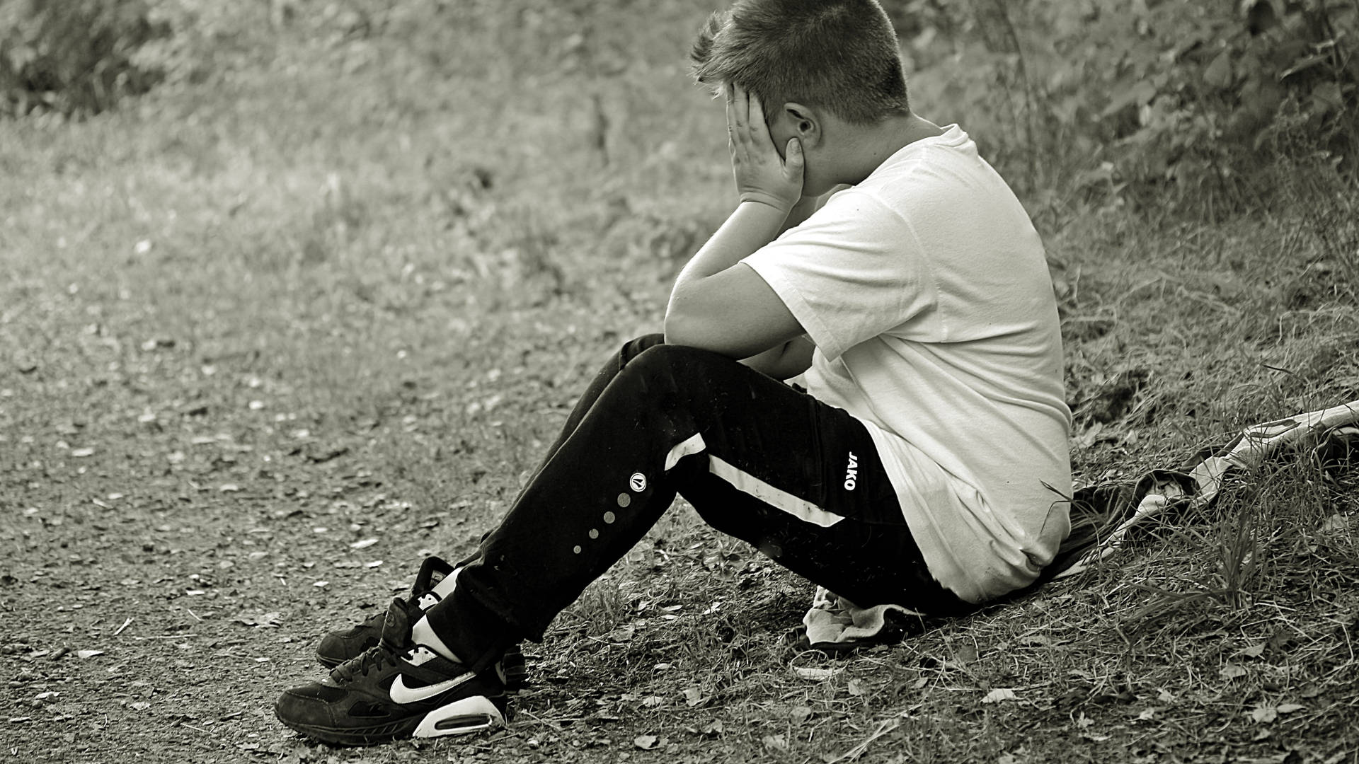 Heartbroken Boy Unleashing His Grief Background