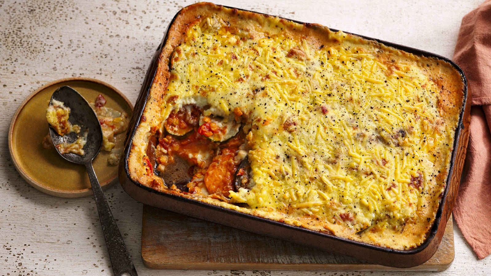 Hearty Tray Of Homemade Baked Moussaka With A Portion Eaten Background