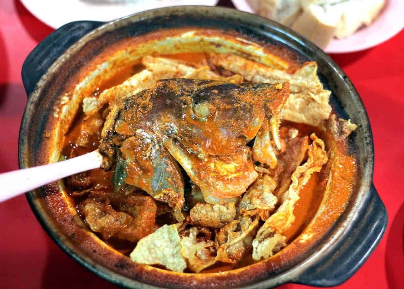 Heavenly Fish Head Curry In A Black Ceramic Pot Background