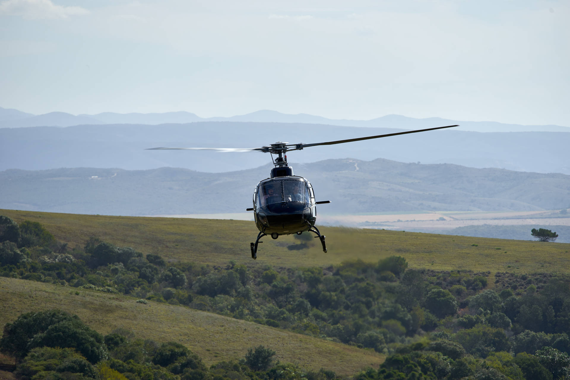 Helicopter Flying Over Landscape Background