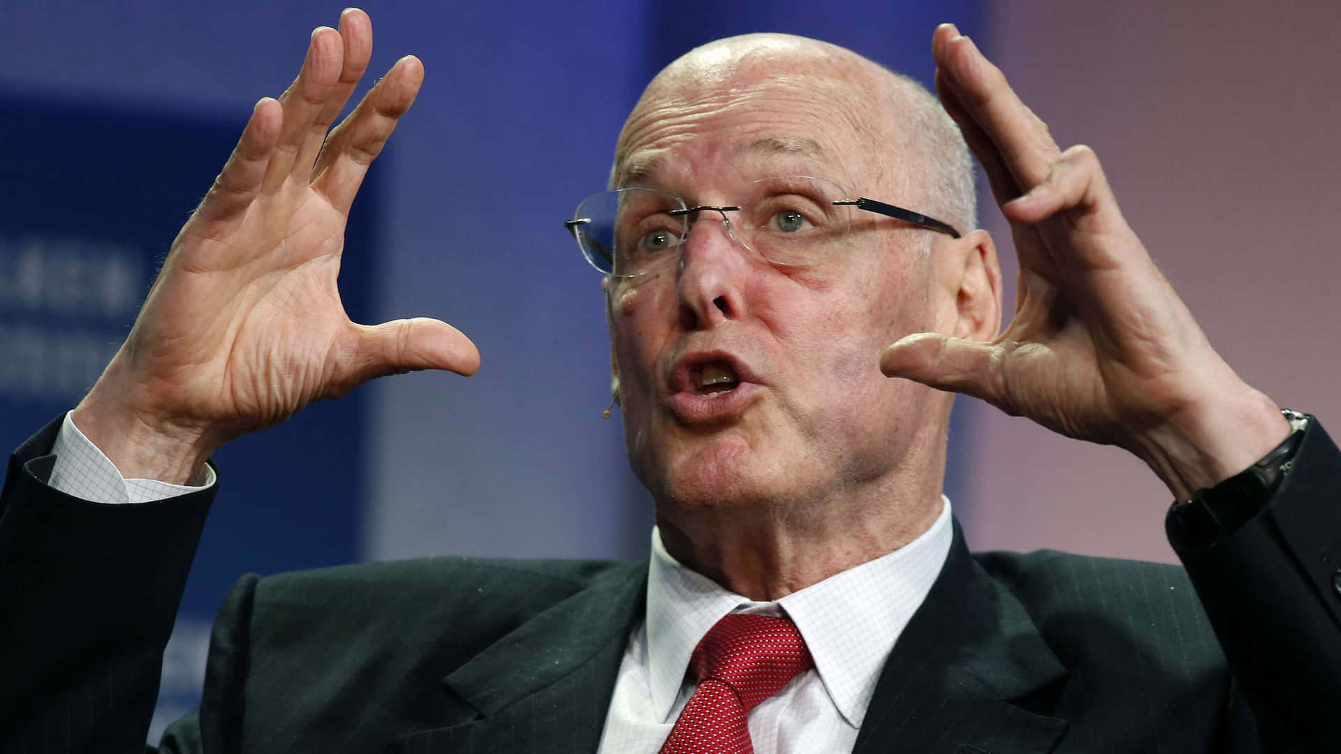 Henry Paulson Animatedly Gesturing During A Speech