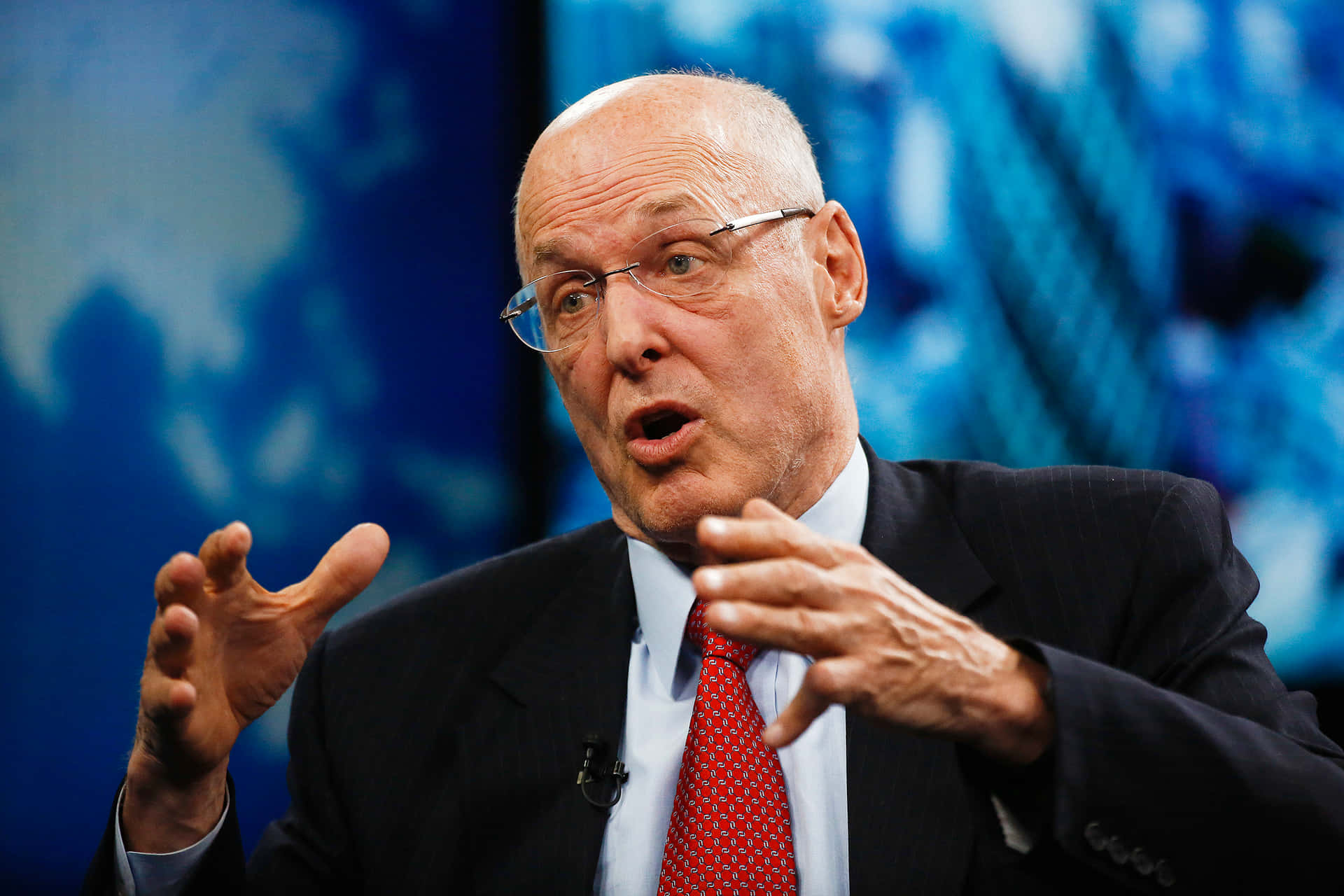 Henry Paulson Delivering Speech On A Show Background
