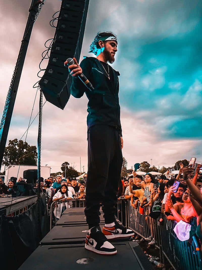 Herencia De Patrones Vocalist Looking At Crowd Background