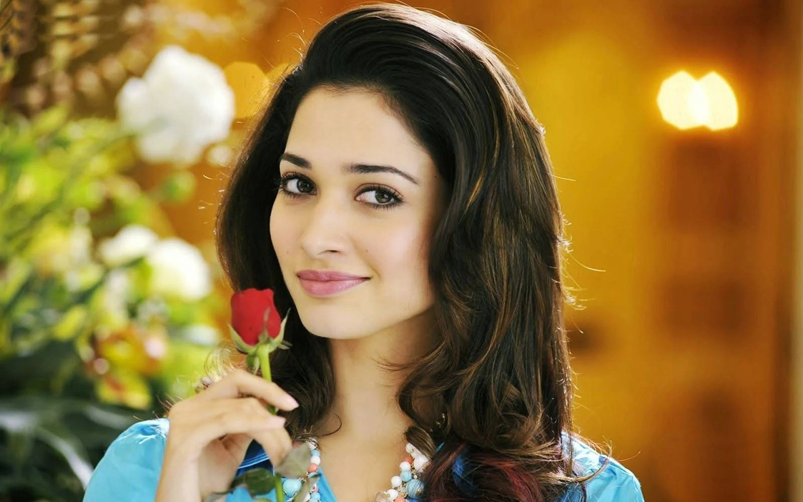 Heroine Actress Holding A Rose Background