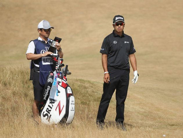 Hideki Matsuyama And Caddie On Dry Golf Course Background