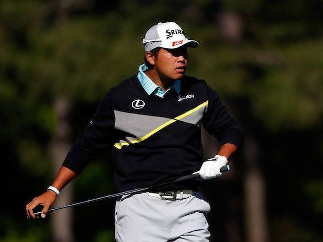 Hideki Matsuyama Poised For A Powerful Swing During A Golf Tournament. Background