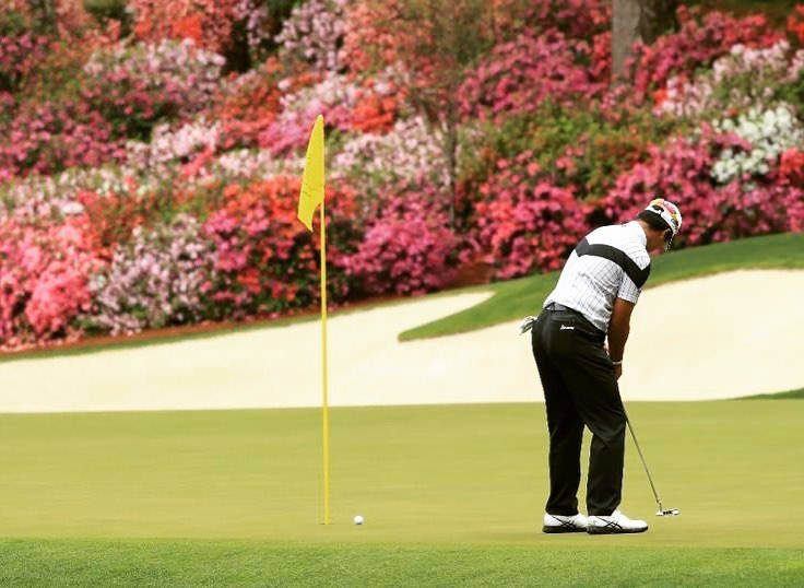 Hideki Matsuyama Skillfully Putting The Golf Ball Background