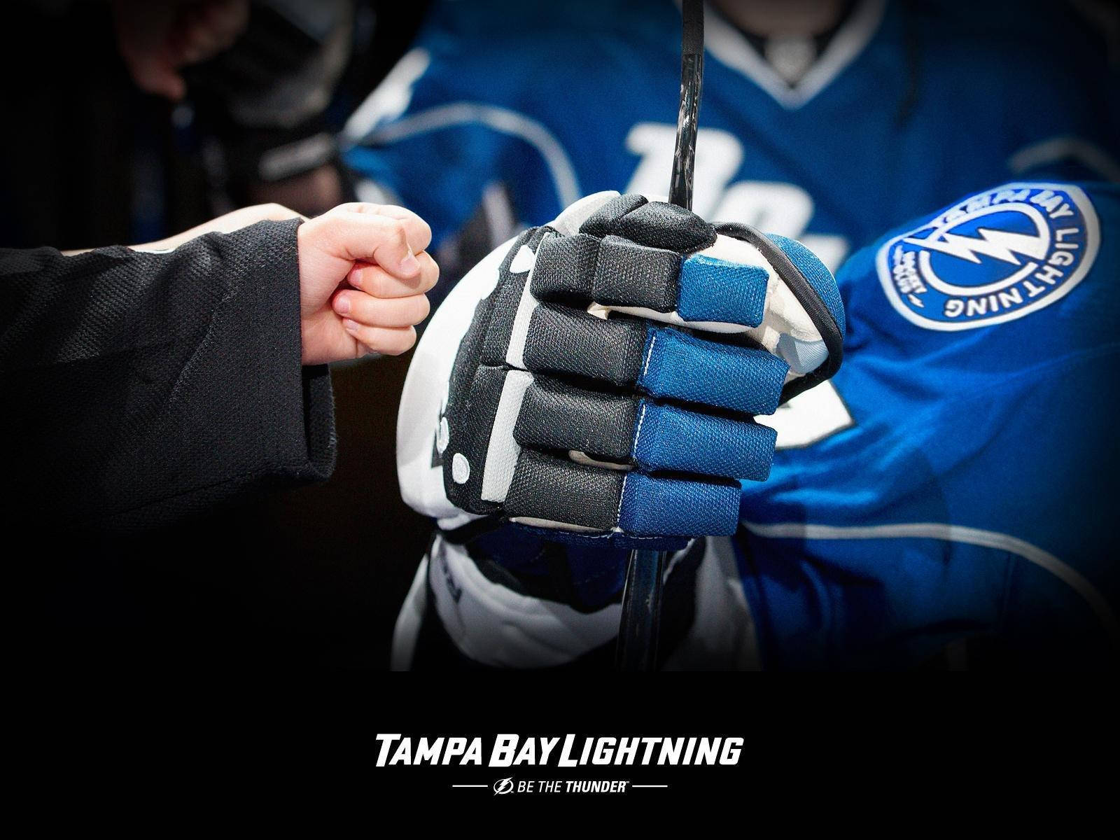 High-energy Fist Bump At Tampa Bay Lightning Game Background