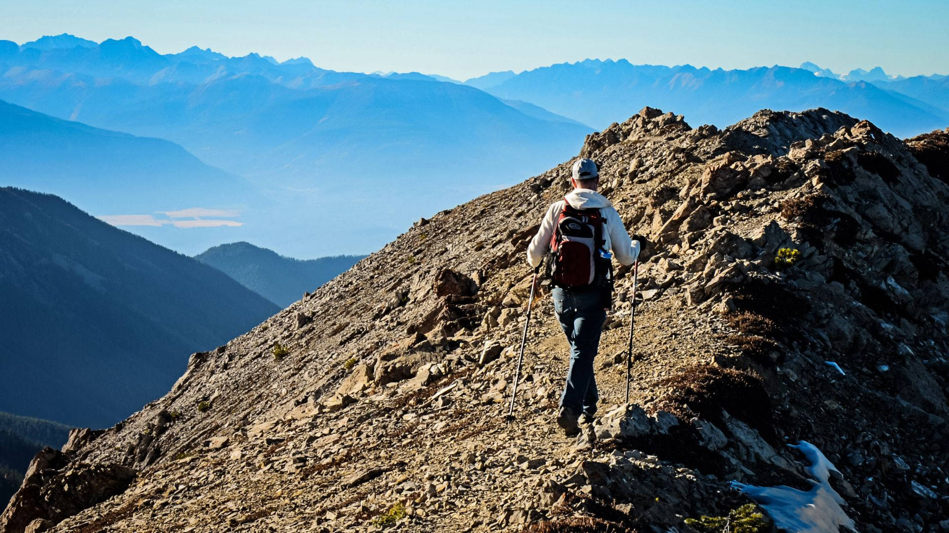 Hiker Journey In Rocky Mountain Background