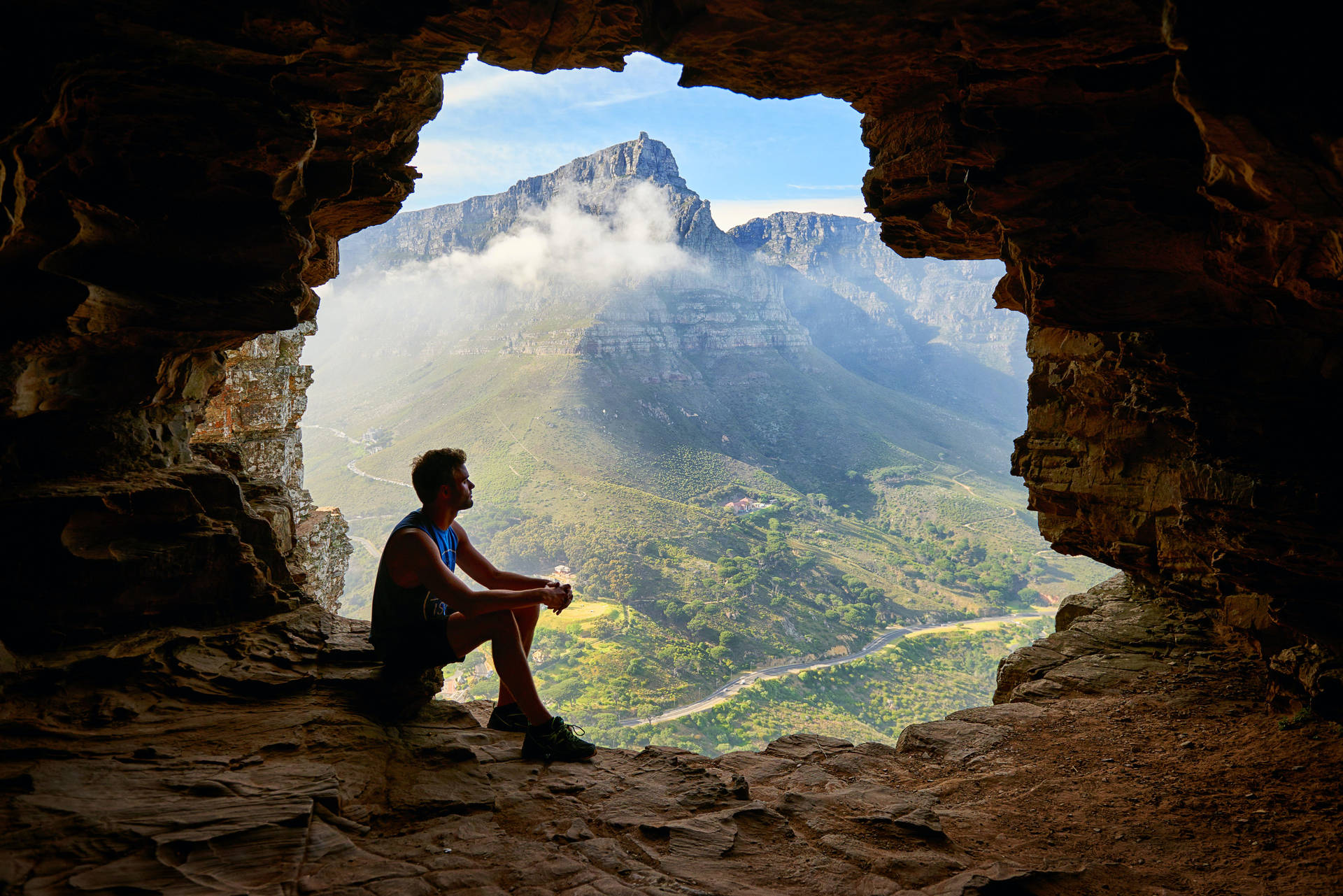 Hiker Sitting Alone Inside A Cave