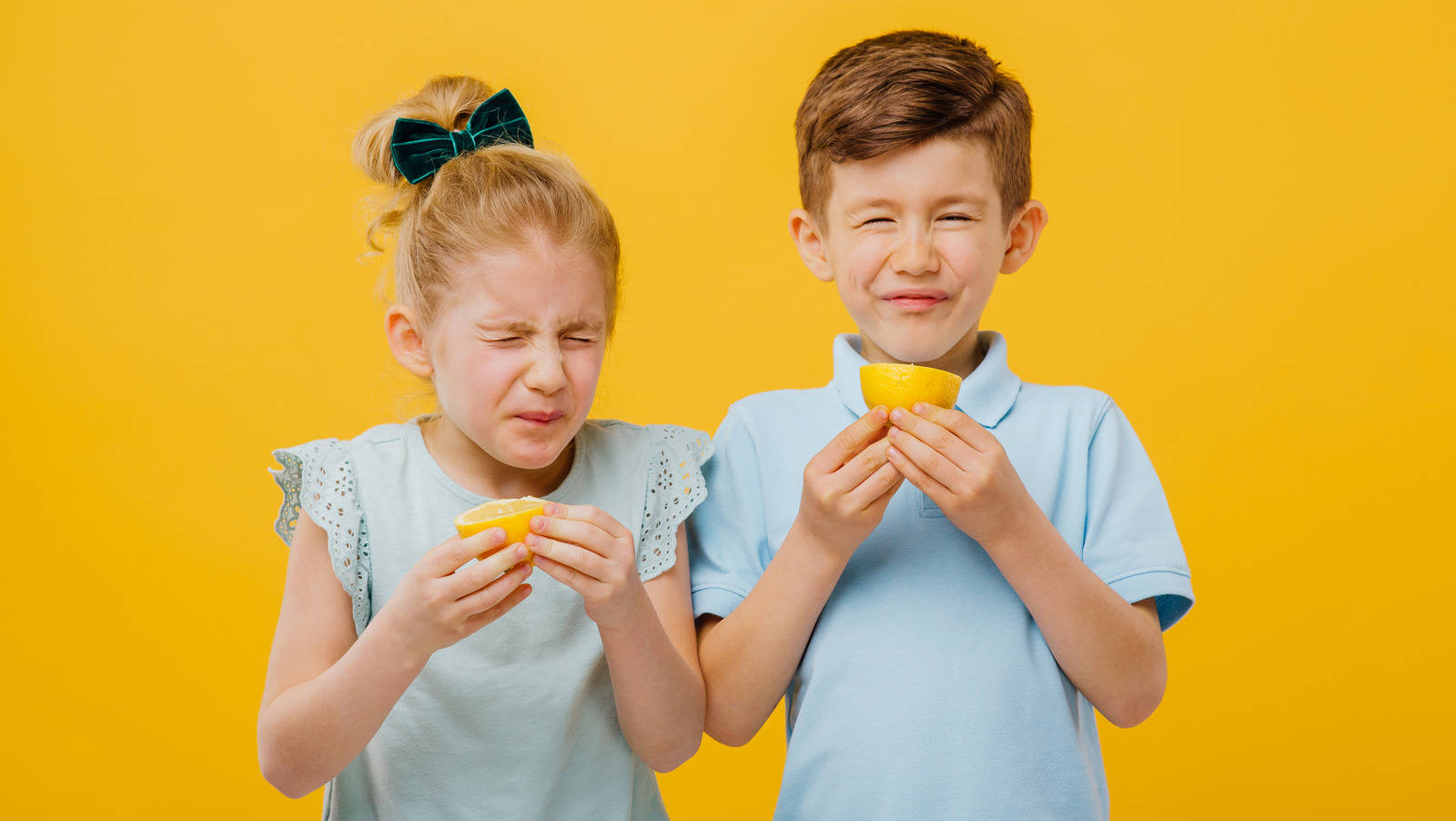 Hilarious Kids Eating Sour Lemon Background