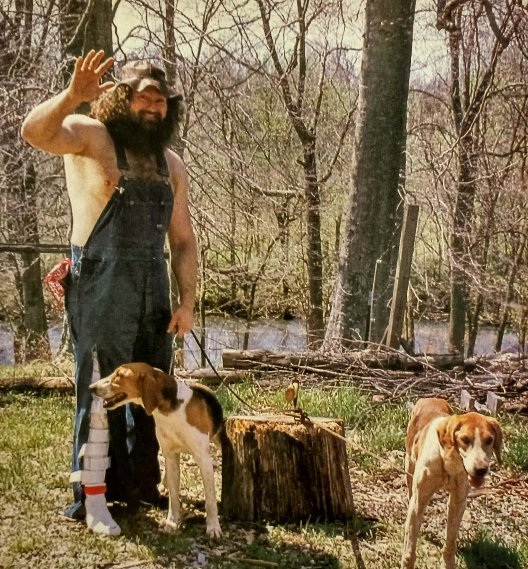 Hillbilly Jim Waving With Dogs Outdoors Background
