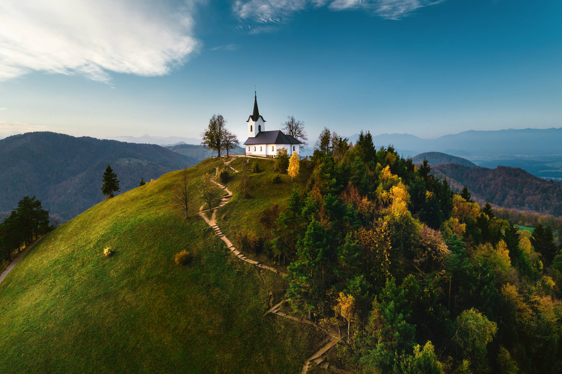 Hilltop Church Overlooking Scenic Countryside Landscape Background