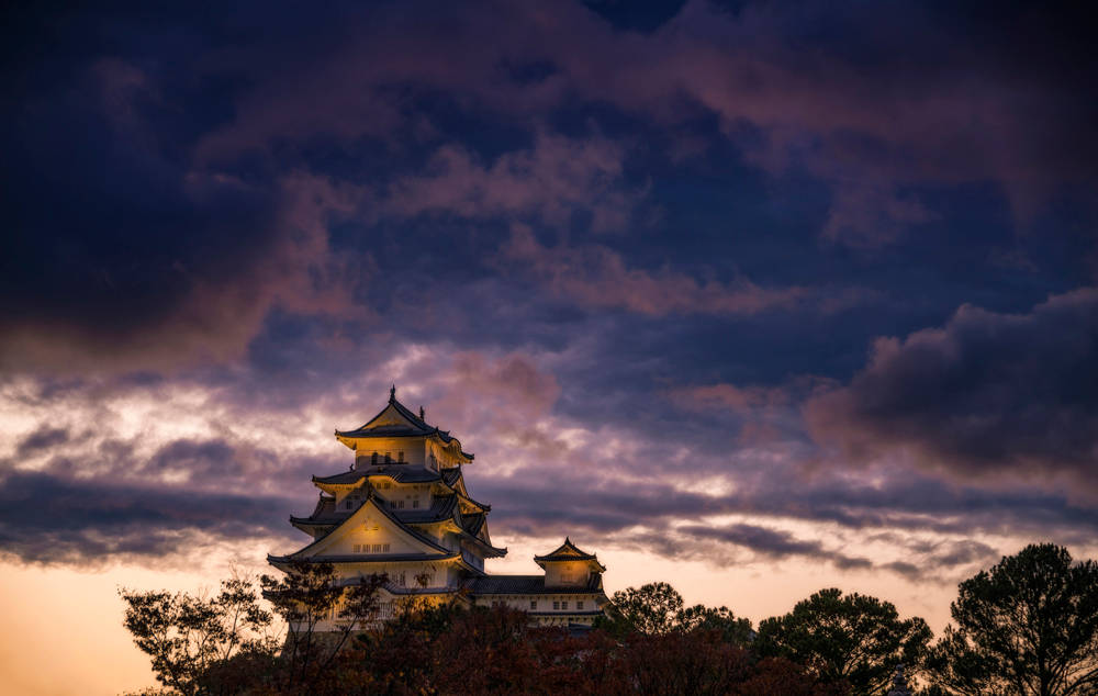Himeji Castle Under Cloudy Skies Background
