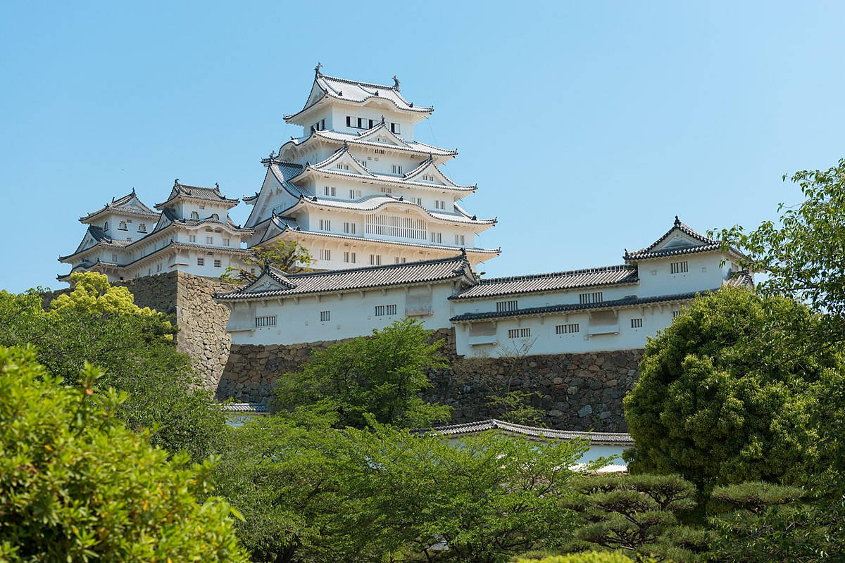 Himeji Castle Within Luscious Trees Background