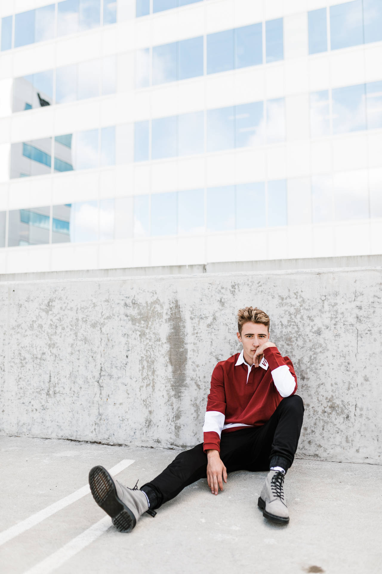 Hipster Leaning On Concrete Wall Background