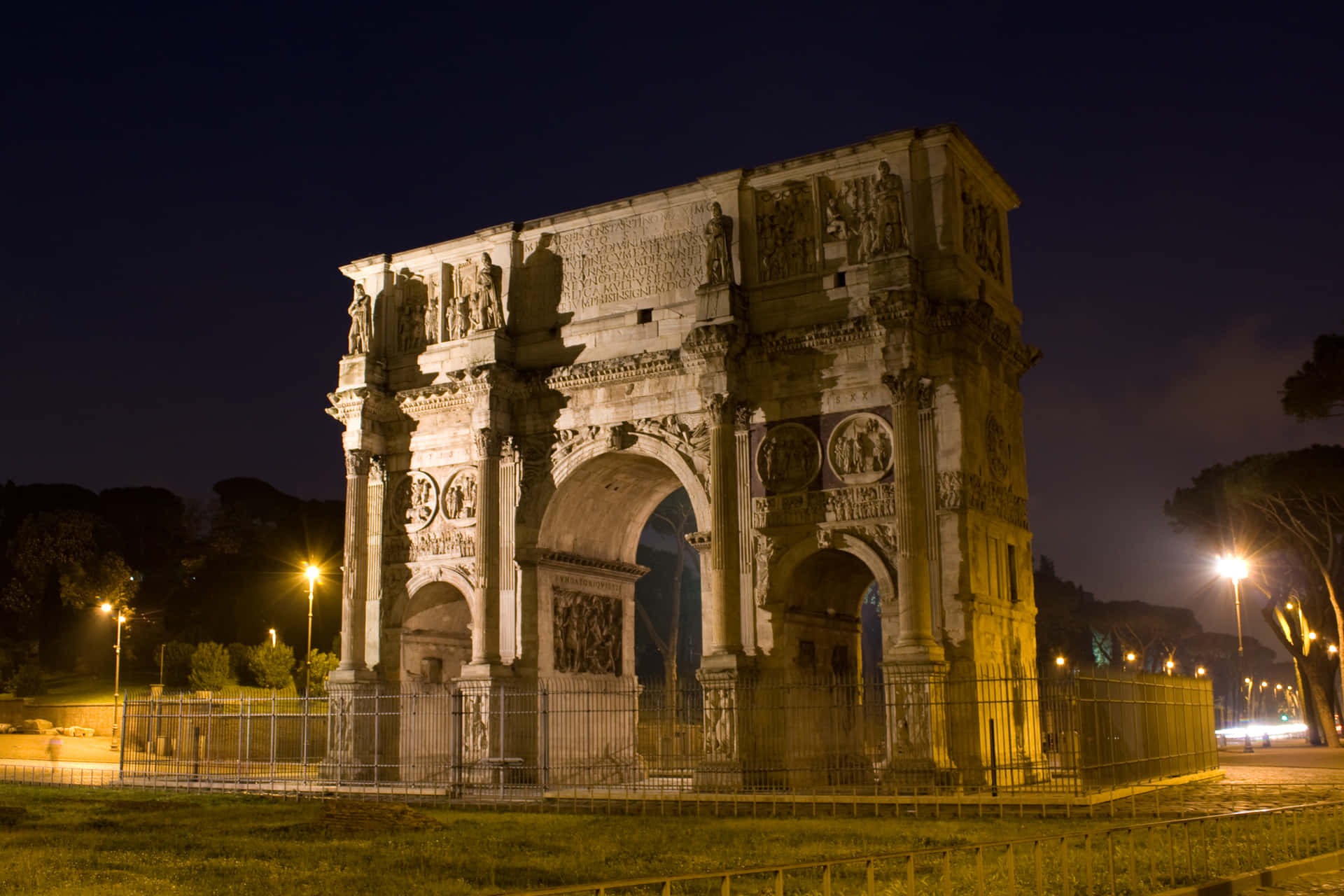 Historic Arch Of Constantine At Night Background