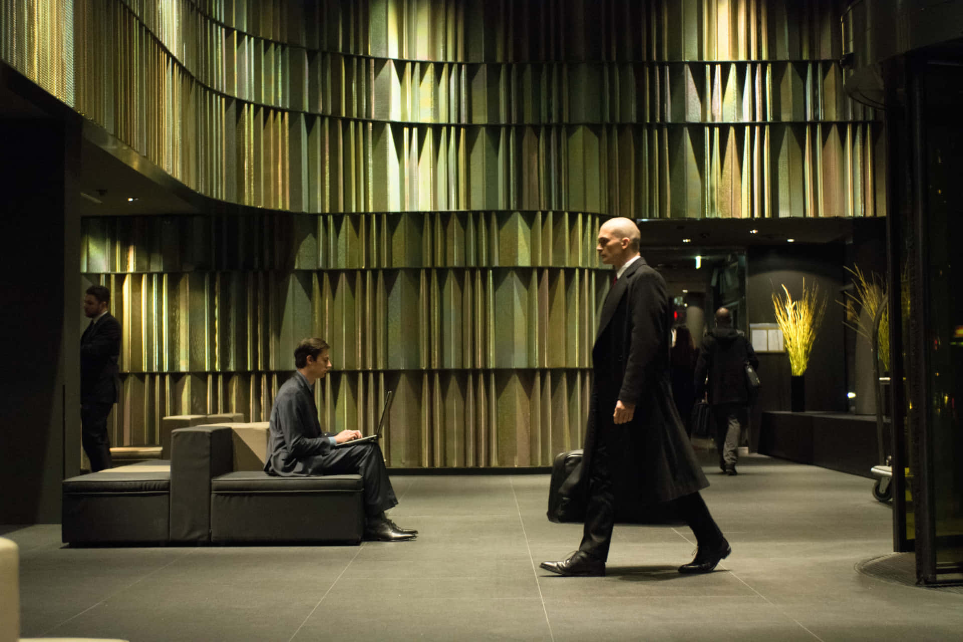 Hitman Agent 47 Walking In A Lobby Background