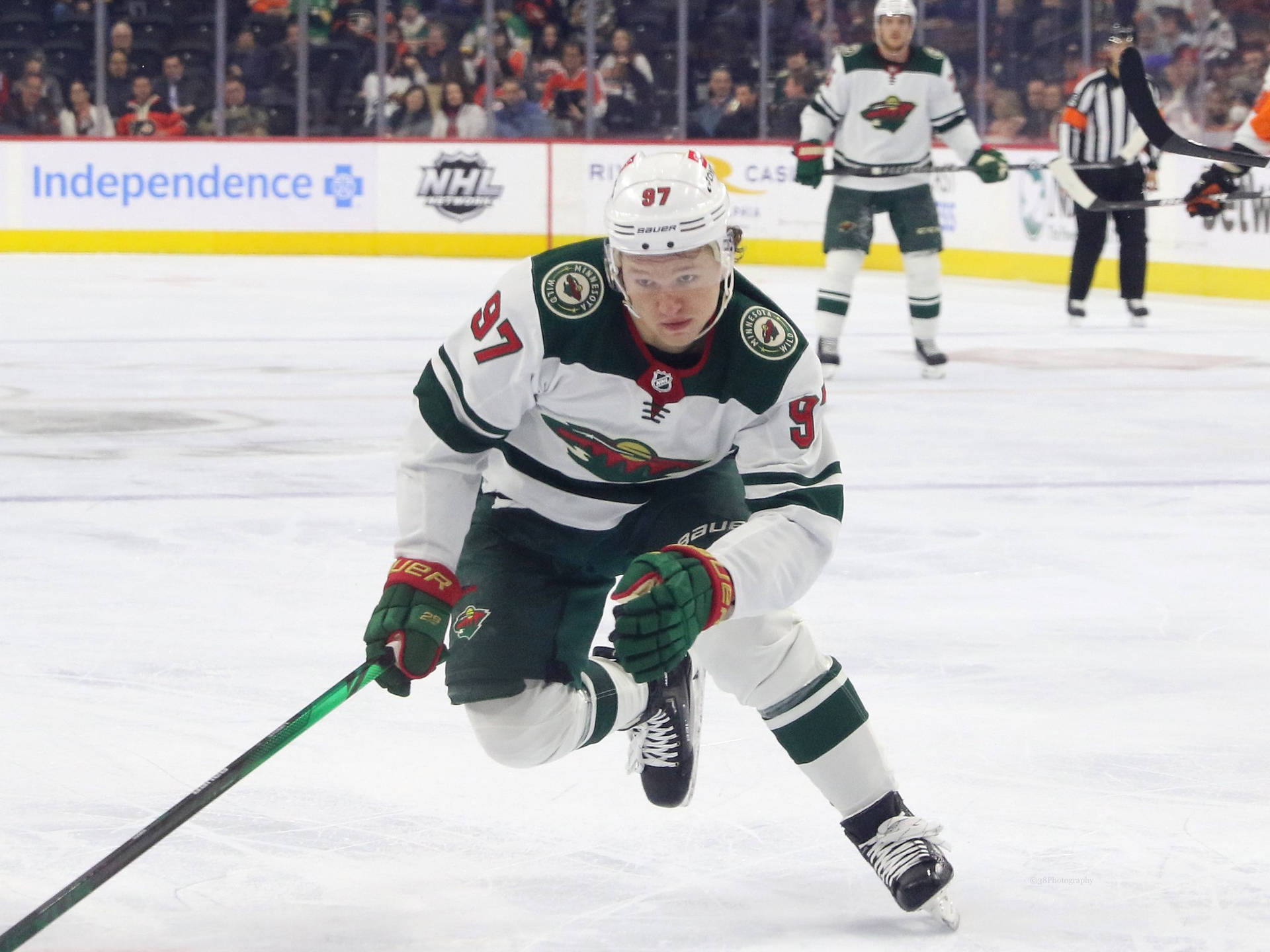 Hockey Player Kirill Kaprizov Gliding On Ice