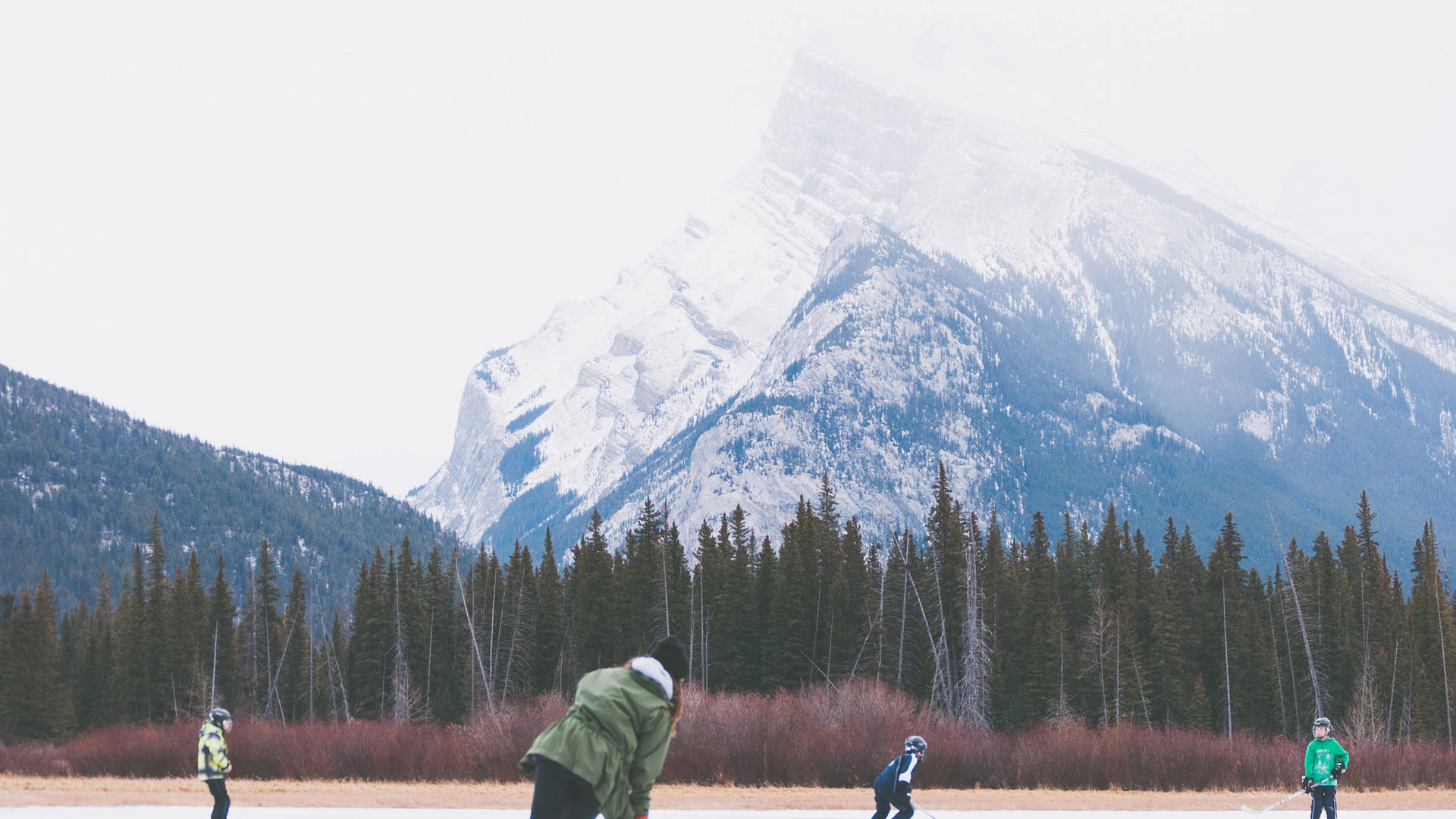 Hockey Players On Banff National Park Background
