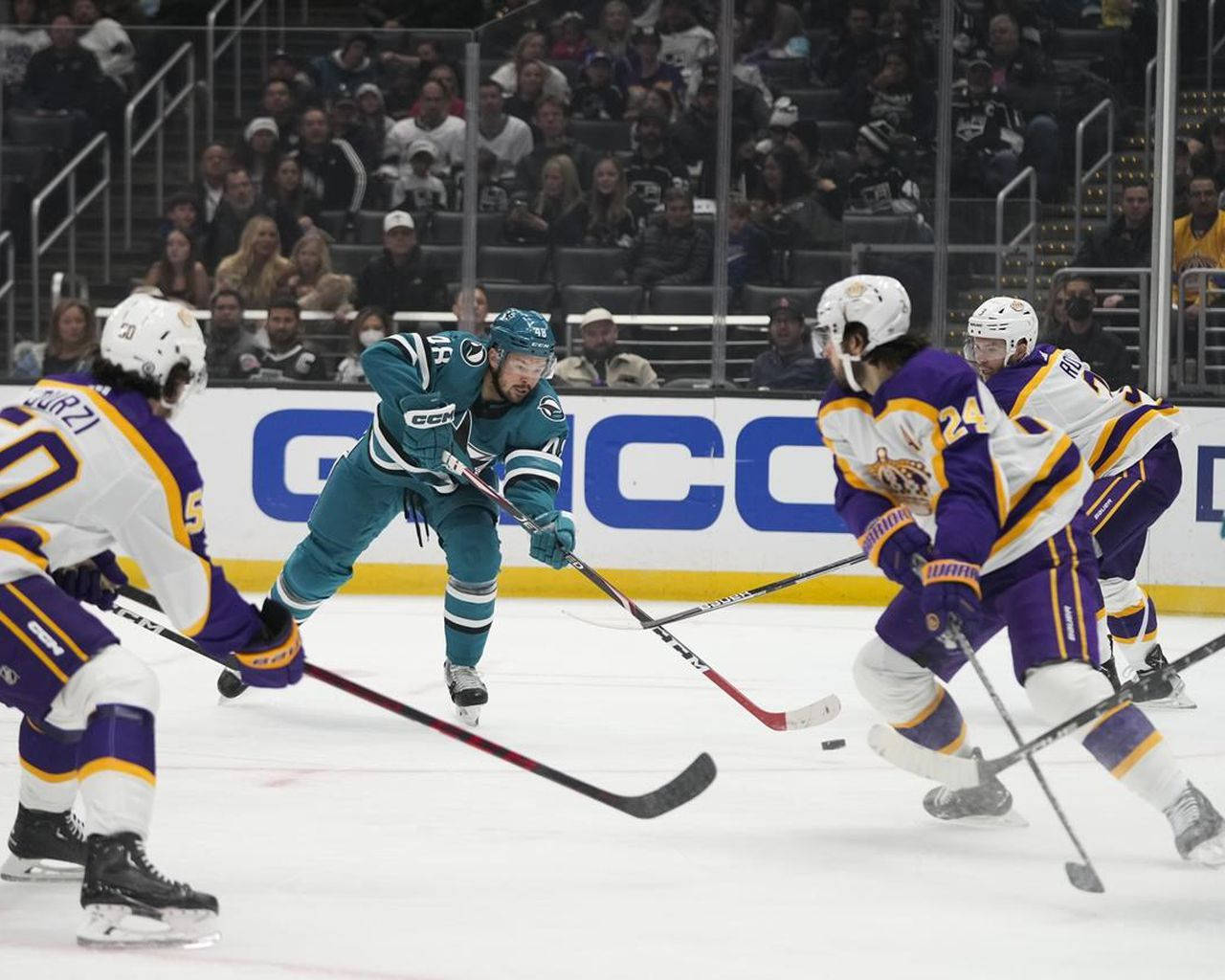 Hockey Pro Tomas Hertl Skillfully Maneuvering Against Defenders On The Ice. Background