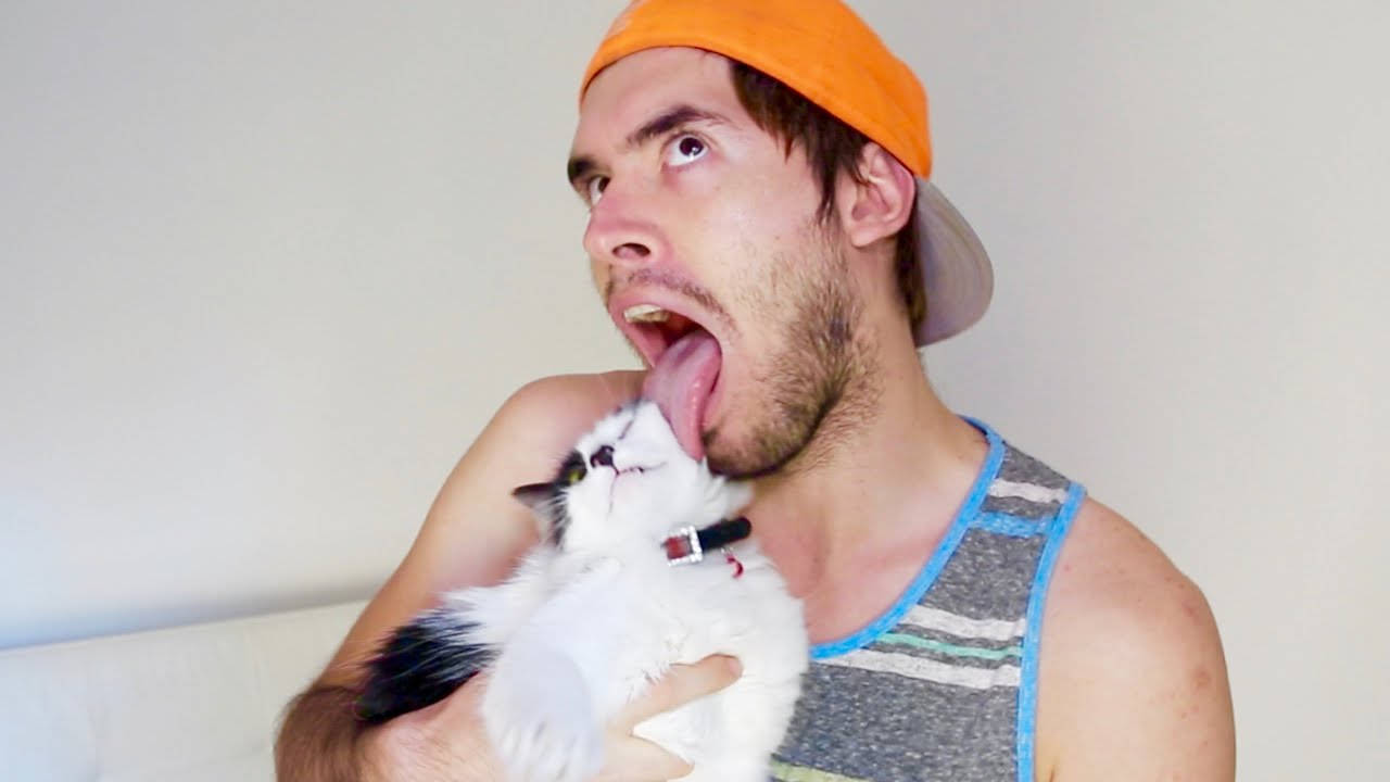 Holasoygerman Posing Playfully With His Cat Background