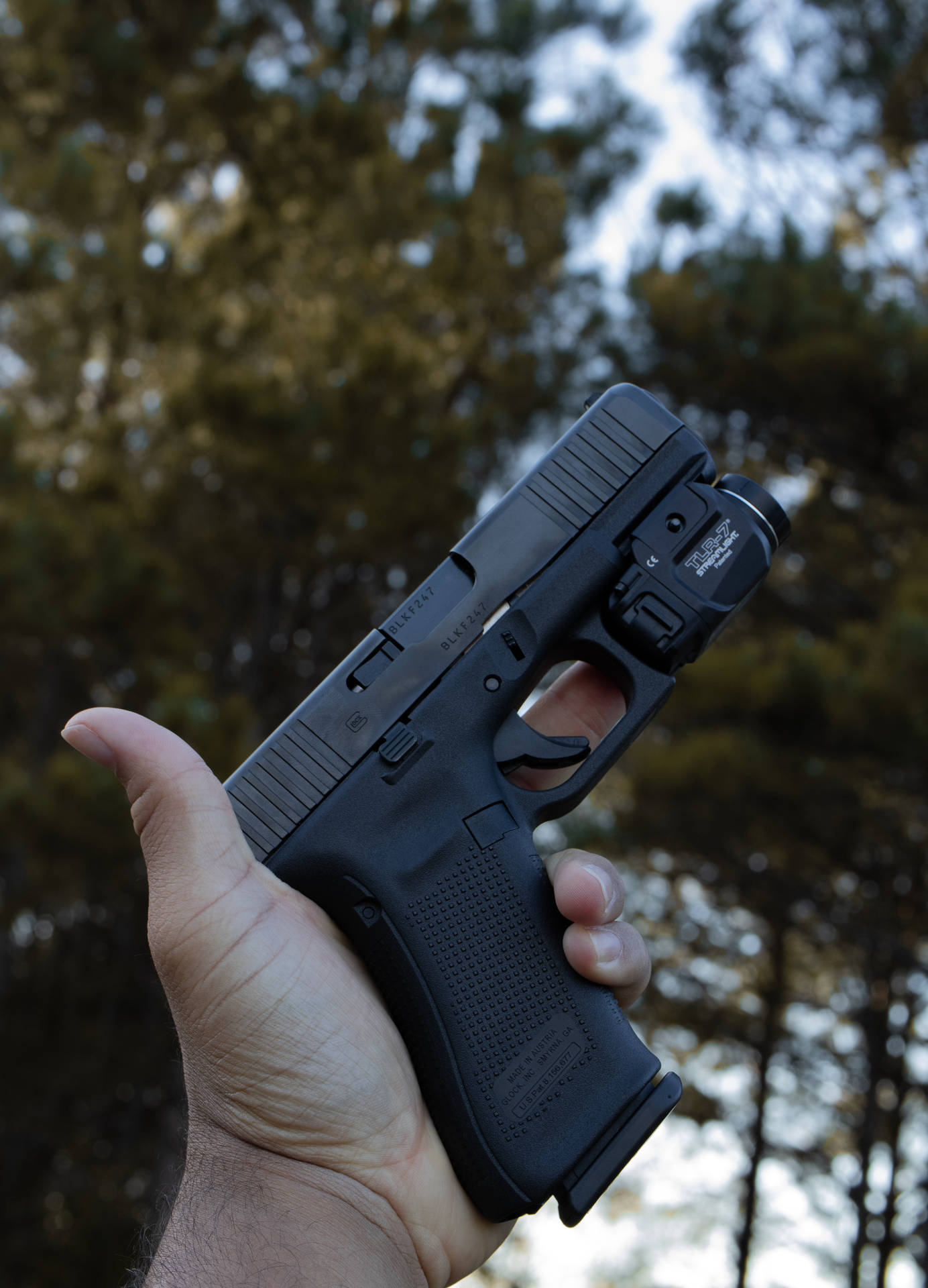 Holding A Glock With Flashlight Background