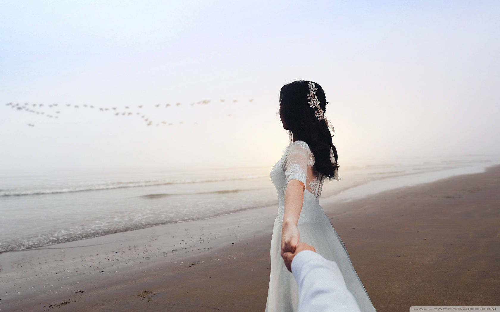 Holding Hands By The Beach In Wedding Gown Background