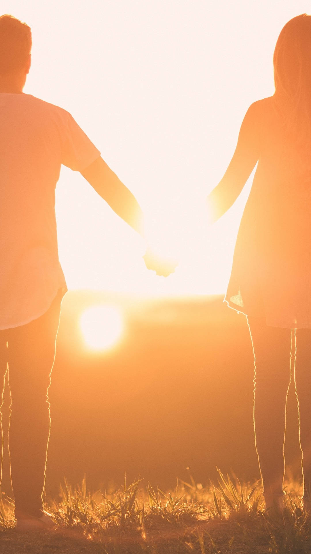 Holding Hands Couple Facing Sunset Back Angle Shot Background