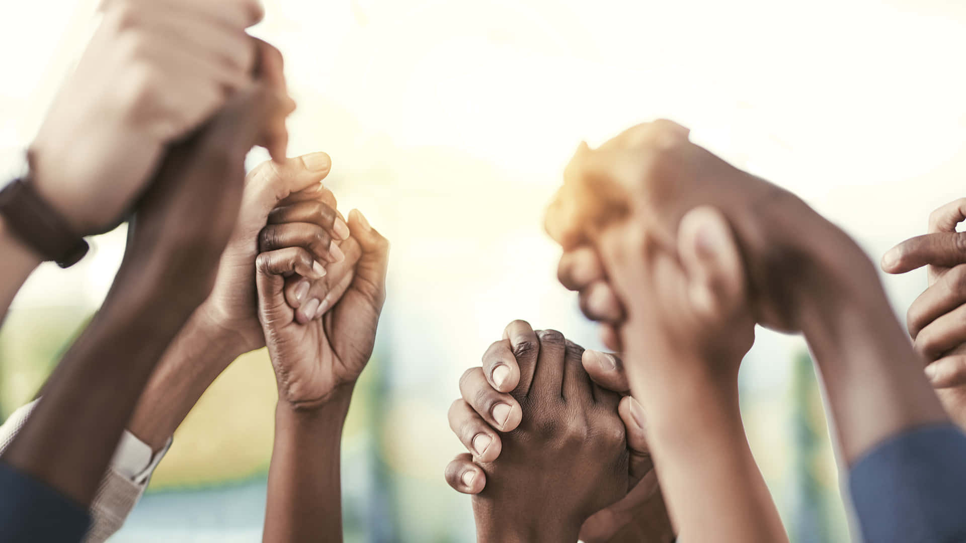 Holding Hands In Solidarity Against Racism Background