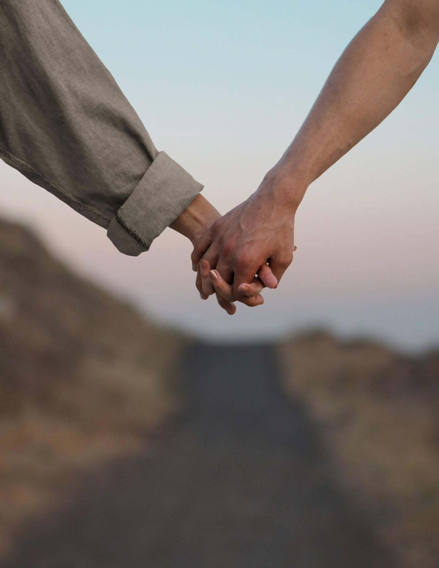 Holding Hands On A Deserted Road Background