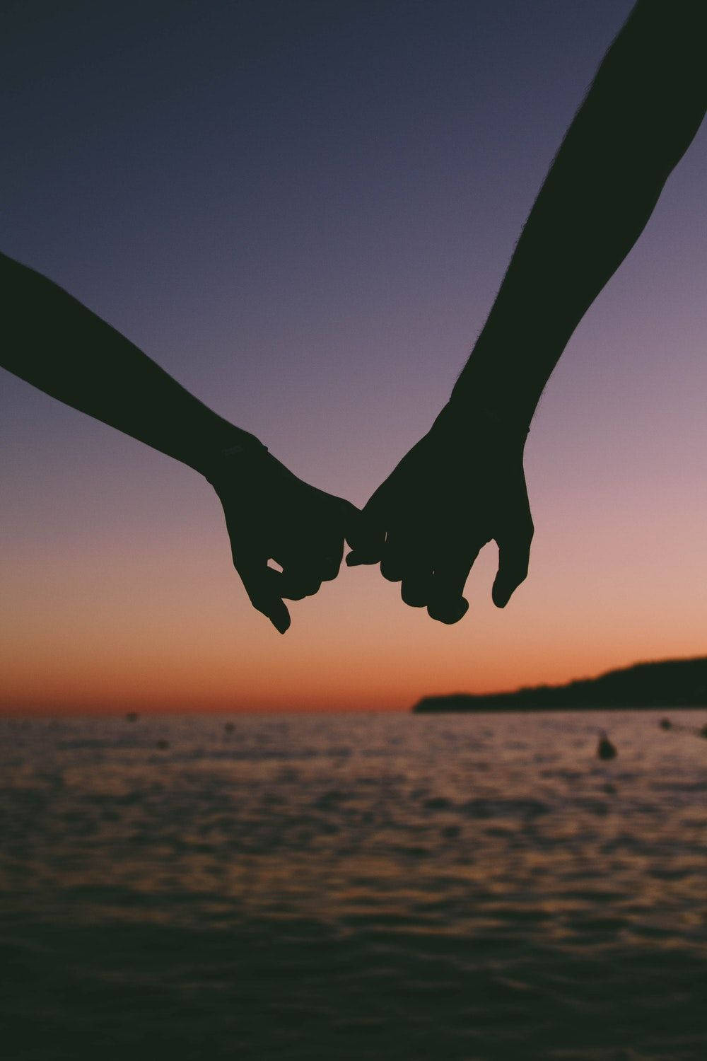 Holding Hands Silhouette At Sea Sunset