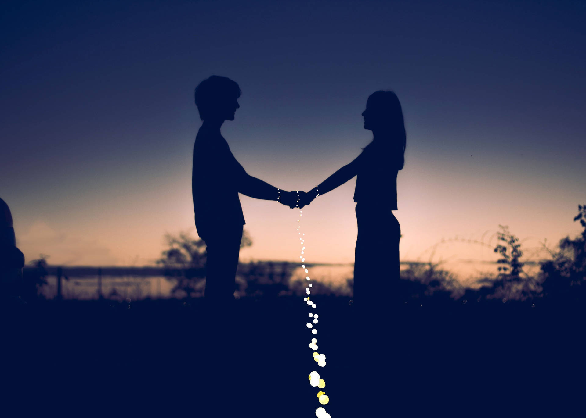 Holding Hands Silhouette On Gradient Sky Background
