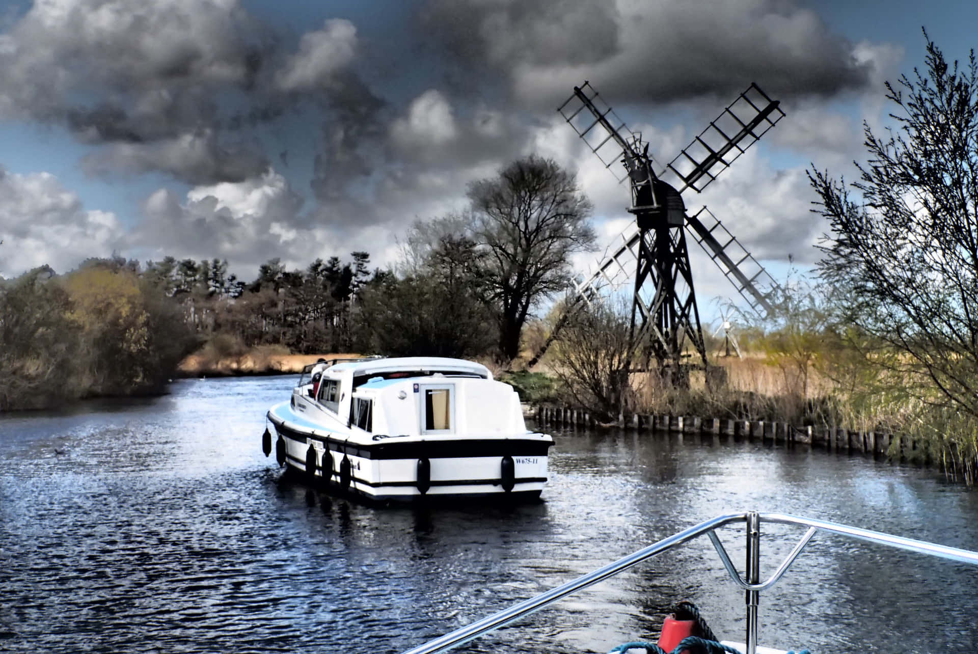 Holiday Cruise On Norfolk Broads Under A Dark Sky Background