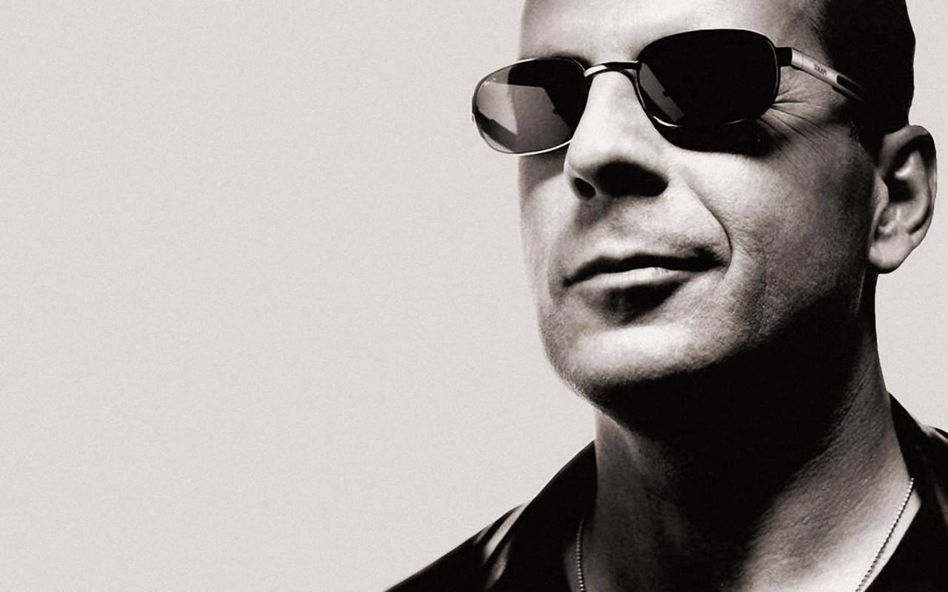 Hollywood Action Star Bruce Willis In Sunglasses Background