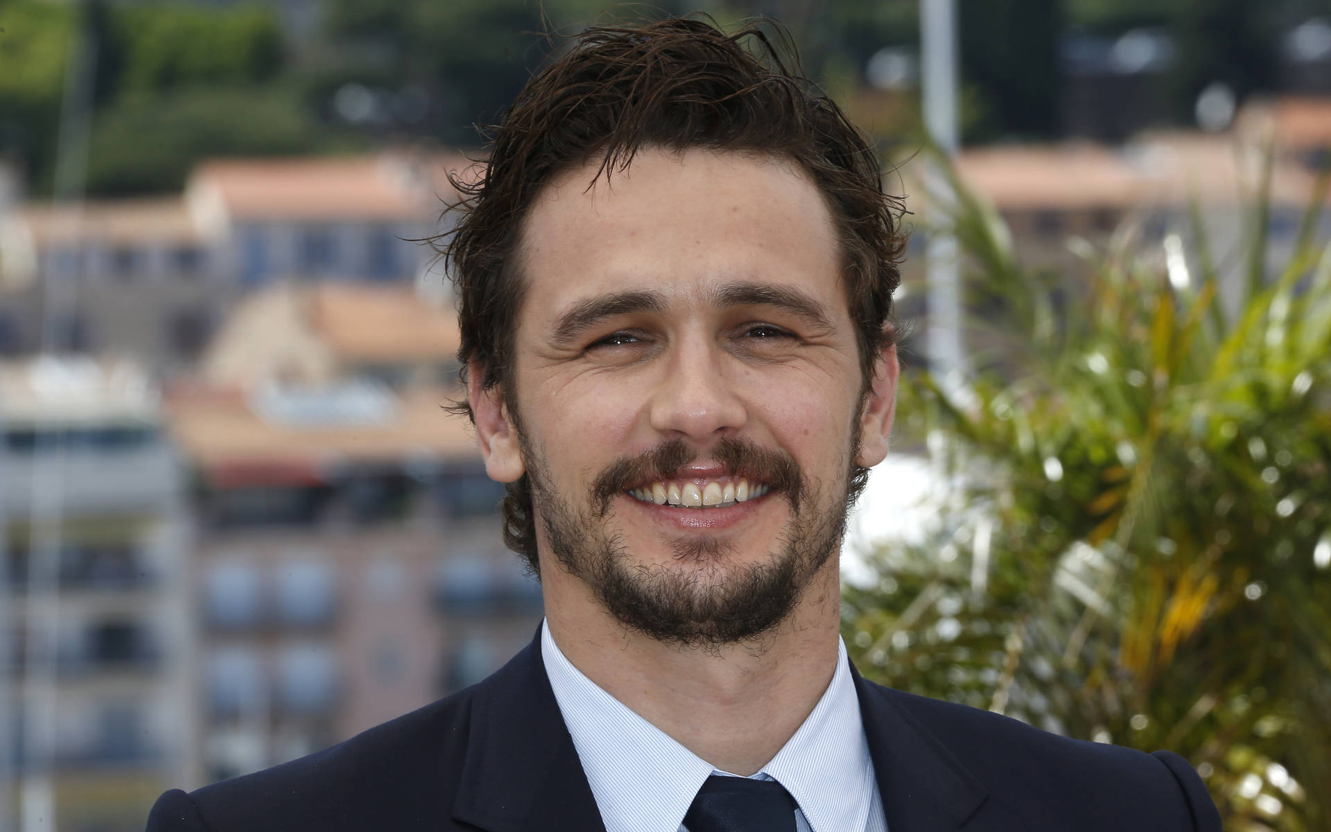 Hollywood Actor James Franco Smiling Background