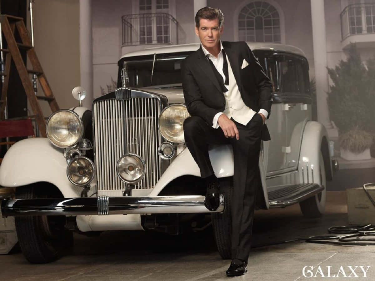 Hollywood Charm Personified. A Suave Snapshot Of Pierce Brosnan. Background