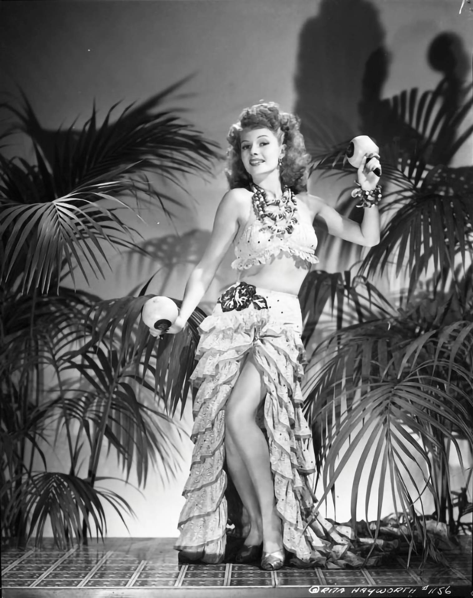 Hollywood Icon Rita Hayworth Dancing With Maracas Background