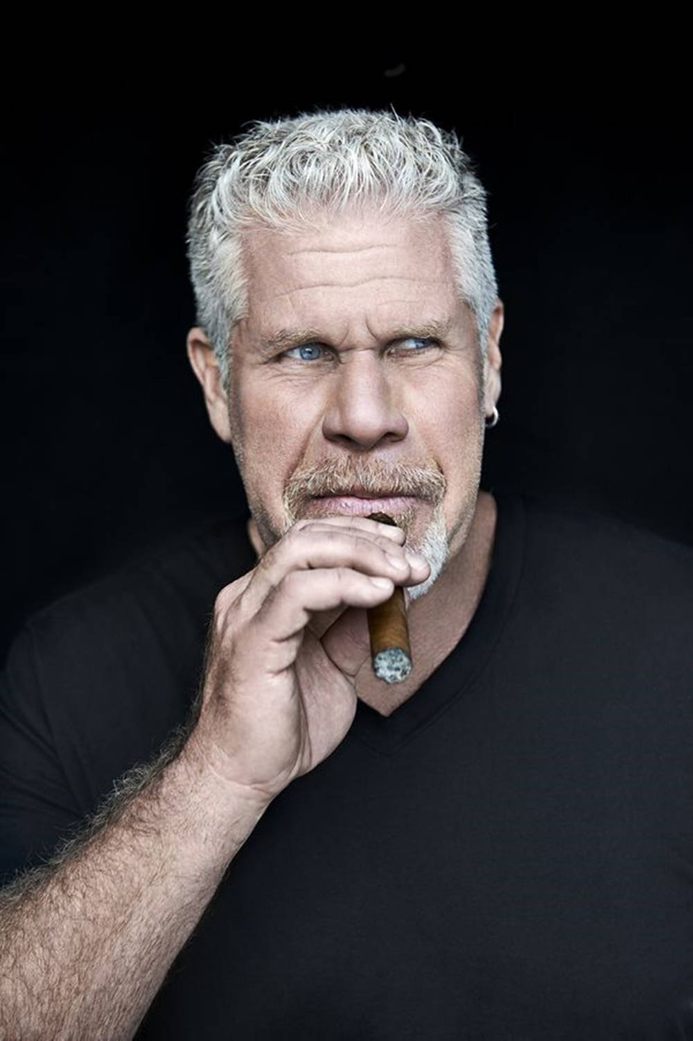 Hollywood Icon Ron Perlman Puffs On A Giant Cigar Background