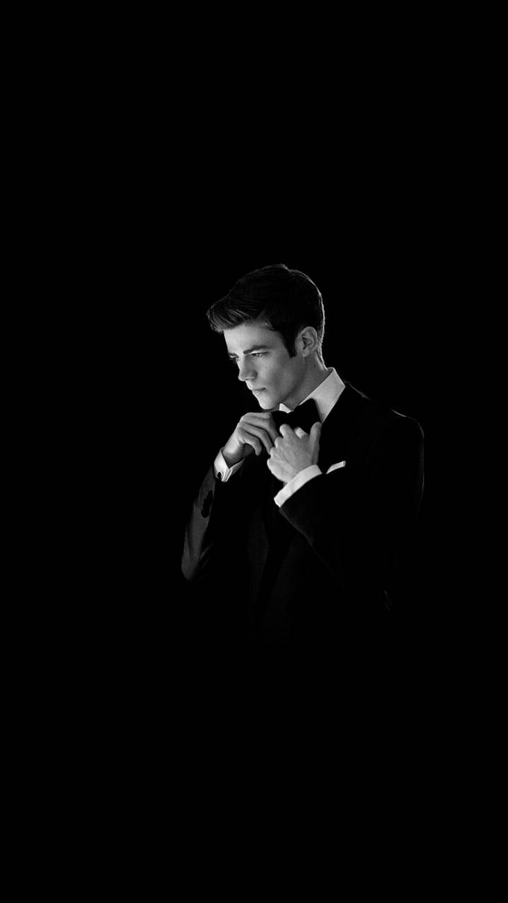Hollywood Star Grant Gustin Looking Suave In Black And White Formal Attire. Background