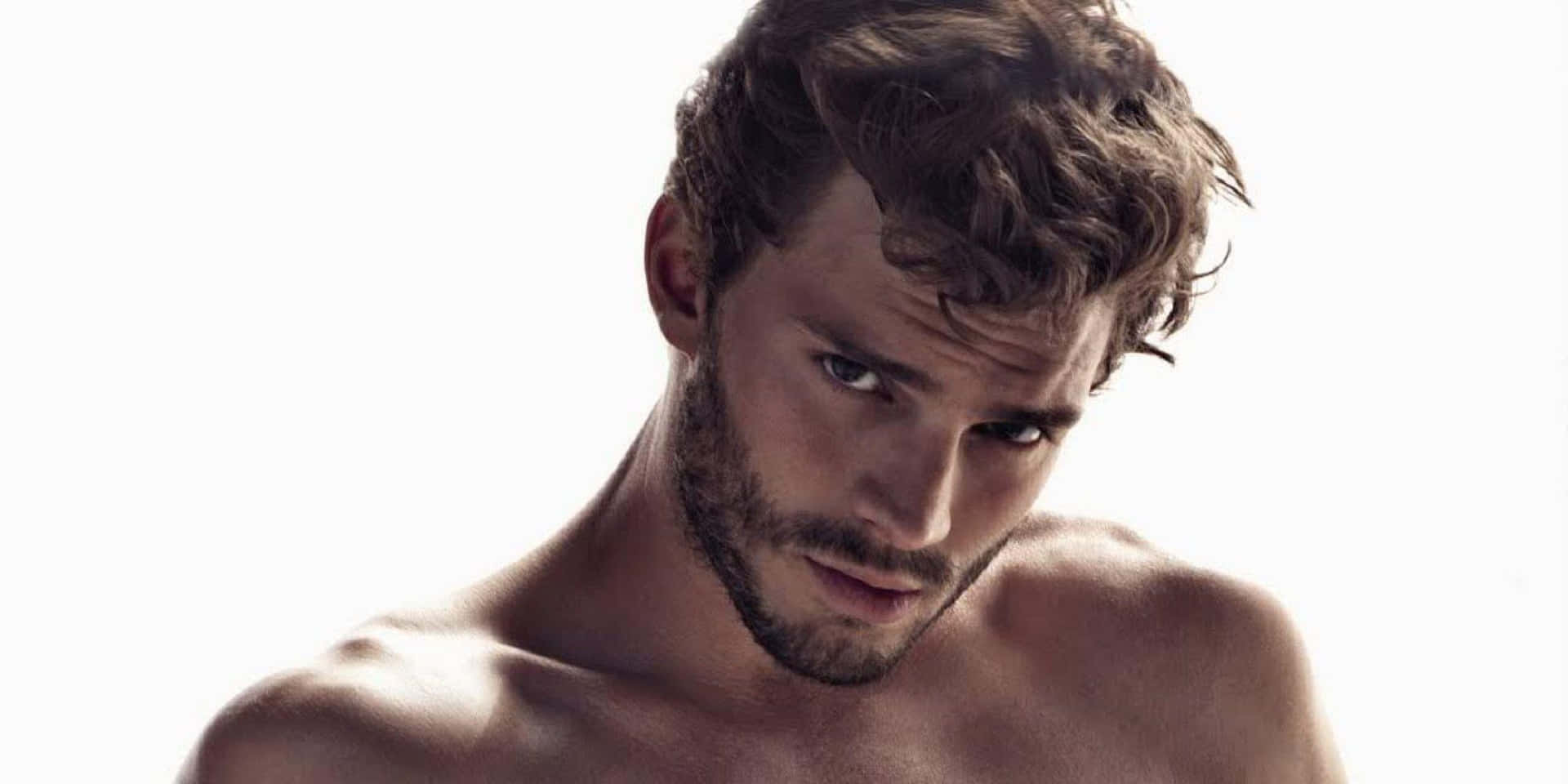 Hollywood Star Jamie Dornan In A Relaxed Pose Background