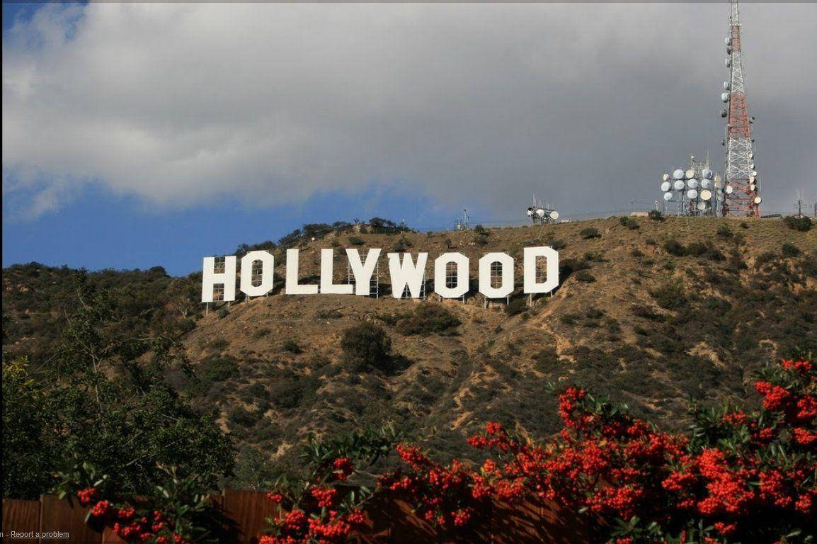 Hollywood Street Sign On Hill Background